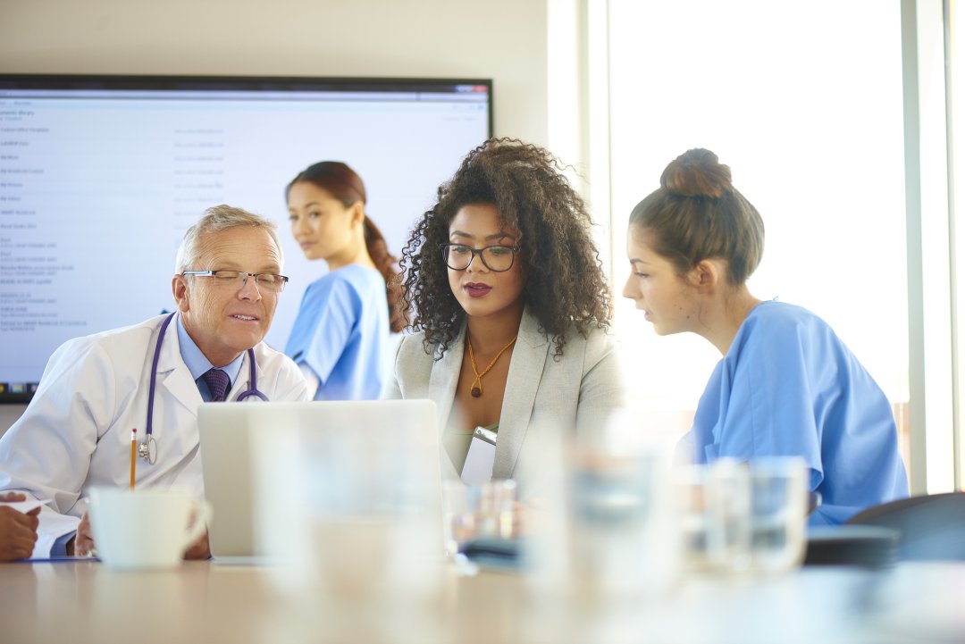 group of doctors looking at a computer