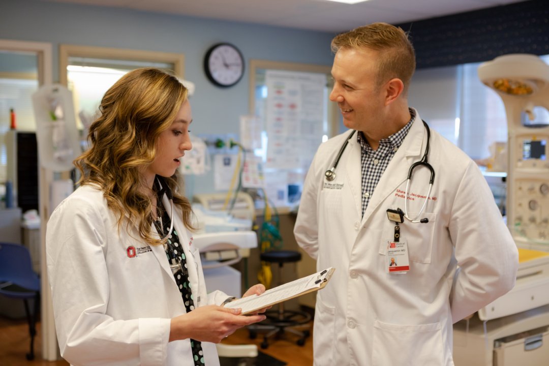 two doctors talking to each other in the hospital 