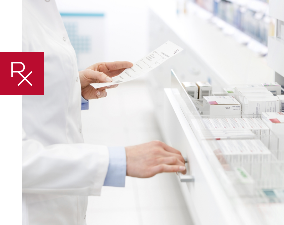 pharmacist pulling medication out of a drawer