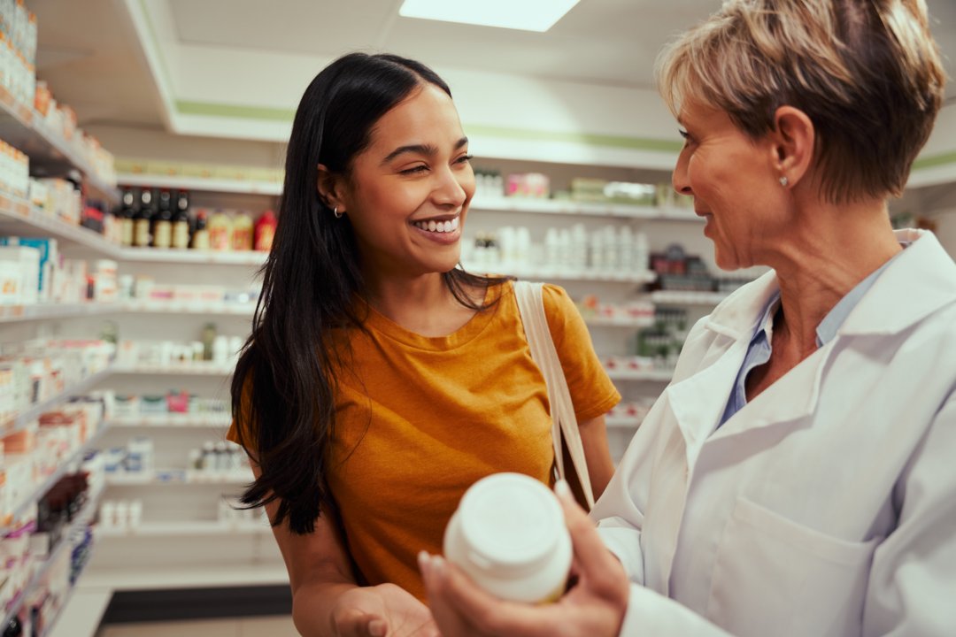 pharmacist helping a woman with her medication